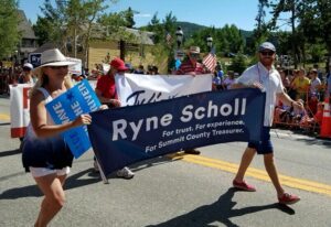 Treasurer Ryne Scholl and Commissioner Elisabeth Lawrence march in the Summit Democrats July 4th Parade