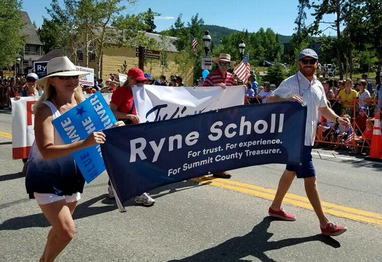 Treasurer Ryne Scholl and Commissioner Elisabeth Lawrence march in the Summit Democrats July 4th Parade